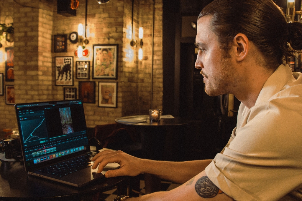 Austen looks at his laptop screen analyzing results.